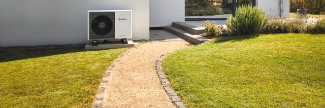 heat pump outside a large white house