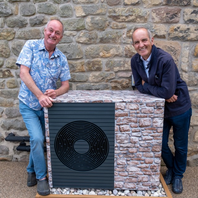 two people gathering around a heat pump